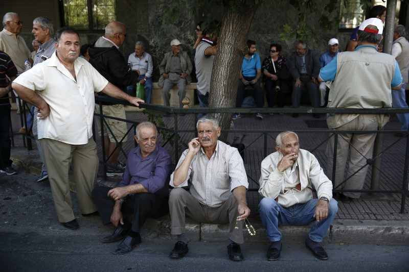 Pensioners rest as they wait for their representatives to conclude a meeting with government Greece's Pension Problem,Greece Pension Problem,Pension Problem,Greek Pension System,European Pensions,Greece's generous pensions,Greece's Pension System