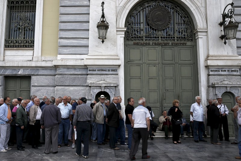 Pensioners wait for the opening of a National Bank branch to receive their monthly pensions in Athens Greece's Pension Problem,Greece Pension Problem,Pension Problem,Greek Pension System,European Pensions,Greece's generous pensions,Greece's Pension System