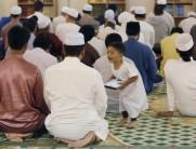 A child shouts at his father during tarawih prayers before Ramadan in Kuala Lumpur, Malaysia