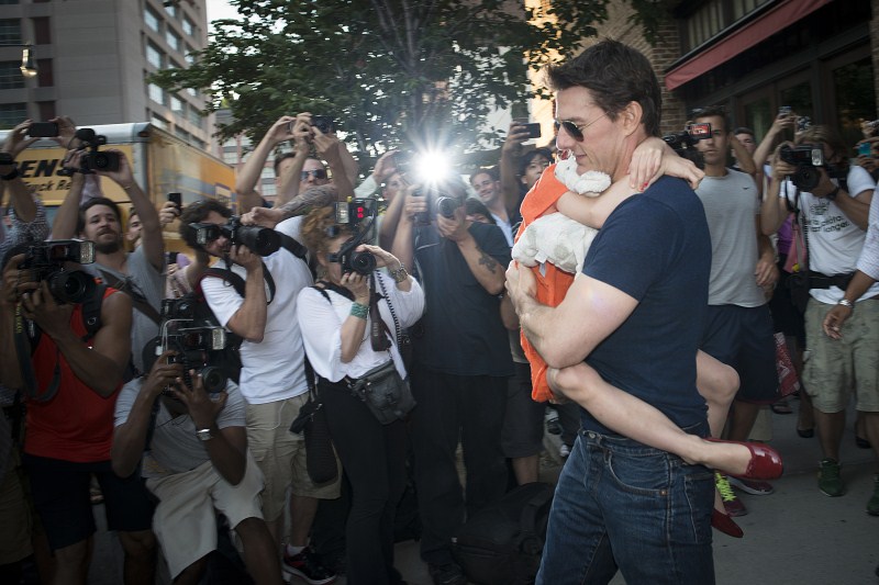 Actor Tom Cruise carries his daughter Suri past a group of photographers Fathers' Day,Fathers' Day 2015,Hollywood celebs with their Kids,celebs with their Kids,Happy Father's Day,dads and their kids,celebrities with their kids,celebrity kids