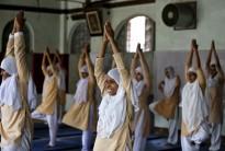 Girls practice yoga inside their school ahead of International Day of Yoga, in Ahmedabad