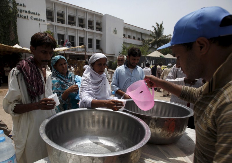 People receive drinking water from a volunteer at a stall, set up outside Jinnah Postgraduate Medical Centre Pakistan Heat Wave,Heat Wave,Pakistan Heat Wave Kills Hundreds,Pakistan,Karachi,Karachi Heat Wave