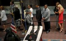 Mourners pay their respects at the casket of the late South Carolina State Senator Clementa Pinckney as he lies in state inside the rotunda of the State Capitol in Columbia