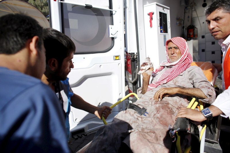 An injured man from the Syrian town of Kobani is carried to a hospital at the Turkish-Syrian border town of Suruc ISIS Attacks,ISIS Attacks Kobani Again,Islamic State,ISIS militants,Syrian town,Islamic State attacks Kobani,Turkey,Sanliurfa province,Sanliurfa