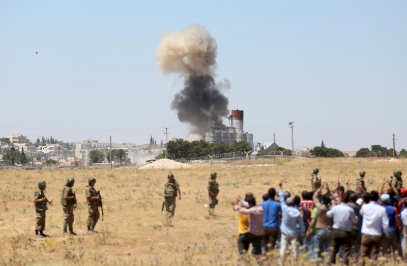Smoke rises in the Syrian town of Kobani as it is seen from the Turkish border town of Suruc in Sanliurfa province, Turkey ISIS Attacks,ISIS Attacks Kobani Again,Islamic State,ISIS militants,Syrian town,Islamic State attacks Kobani,Turkey,Sanliurfa province,Sanliurfa