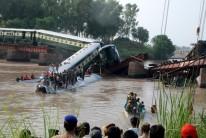 Pakistan army soldiers conduct a search operation after a train fell into a canal near Gujranwala, Pakistan