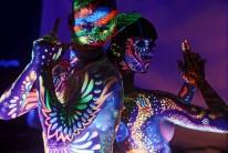 Models display designs in ultraviolet paint during the annual World Bodypainting Festival in Poertschach
