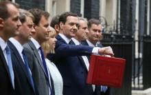 Britain's Chancellor of the Exchequer, George Osborne, holds up his budget case for the cameras