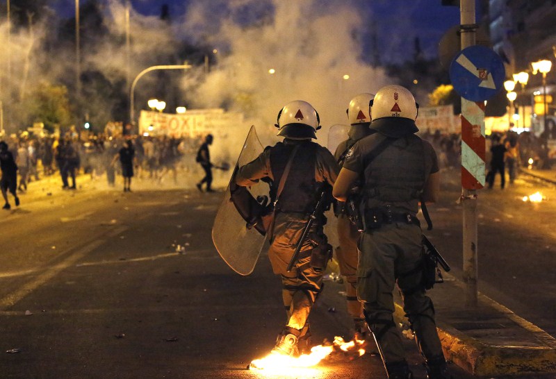 Masked anti-establishment youths and anti-austerity protesters face riot police during clashes in Athens Protests Turn Violent in Greece,Protests in Greece,Anti-austerity movement in Greece,Greece protests turn violent,bailout deal,amid protests,anti-establishment protesters