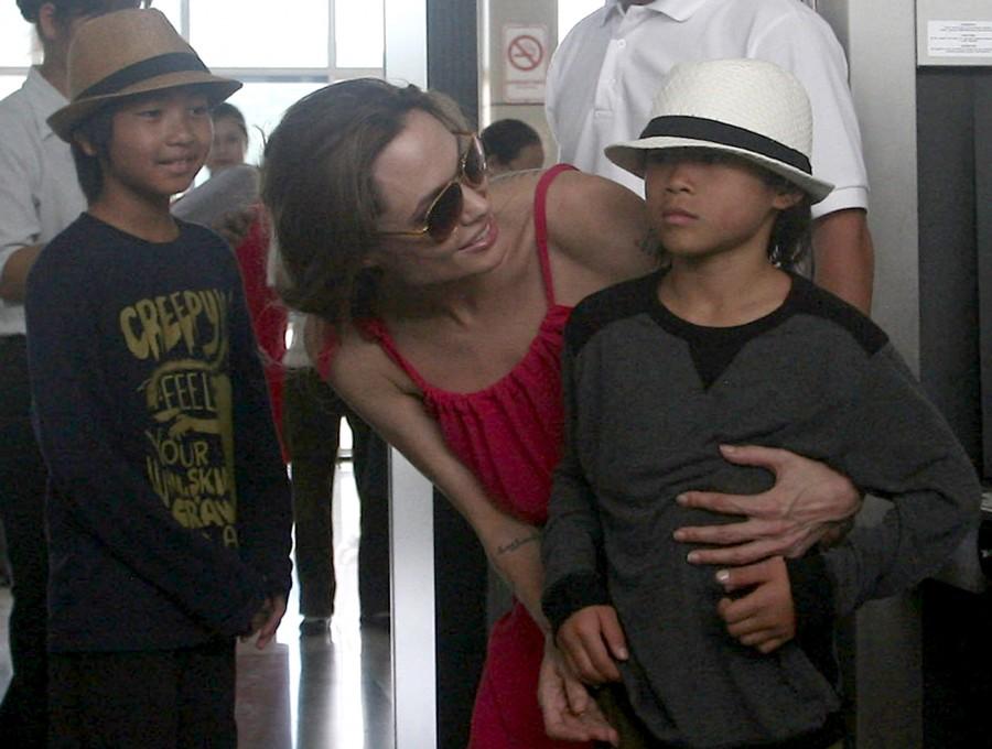 Angelina Jolie (C) chats with her adopted son Pax Thien from Vietnam next to Maddox (L) from Cambodia at a security check point before leaving Con Dao island, off Vietnam's southern coast. Angelia jolie,angelia jolie photos,angelia jolie special moments,angelia jolie upcoming films
