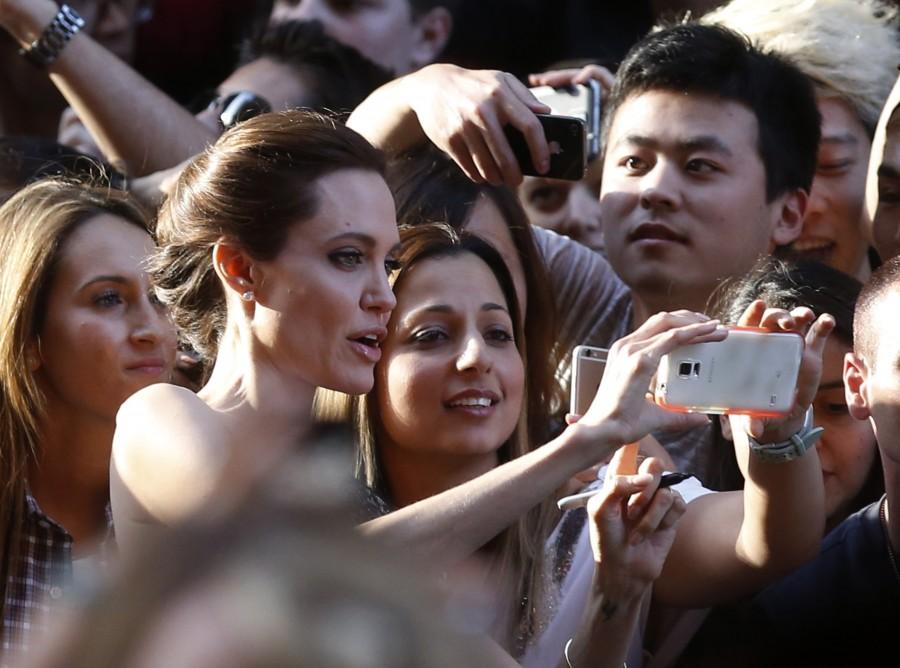 Angelina Jolie takes a 'selfie' with fans at the world premiere of her film Angelia jolie,angelia jolie photos,angelia jolie special moments,angelia jolie upcoming films