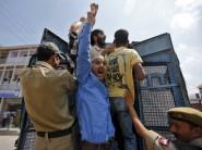 Supporters of Awami Ittihad Party (AIP), a pro-India party, raise their hands and shout slogans from a vehicle after being detained by Indian police during a protest against the hanging of Yakub Memon, in Srinagar.