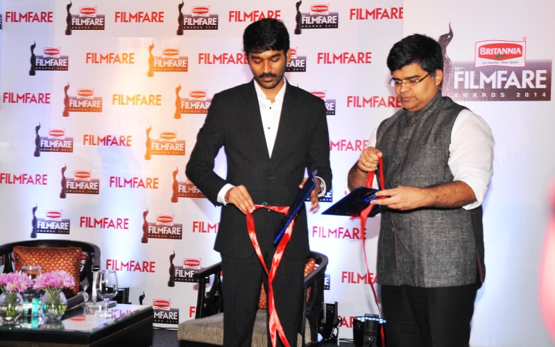 Dhanush and Jitesh Pillaai (Editor, Filmfare Magazine) at the '62nd Britannia Filmfare South Awards' special issue launch at The Leela Palace. Dhanush,Dhanush on the cover of special edition of Filmfare South,Dhanush and Jitesh Pillaai,Jitesh Pillaai,Filmfare South,Dhanush unveils the Filmfare cover,Dhanush on Filmfare cover,Filmfare cover page,Dhanush latest pics,Dhanush latest images,Dhanush l