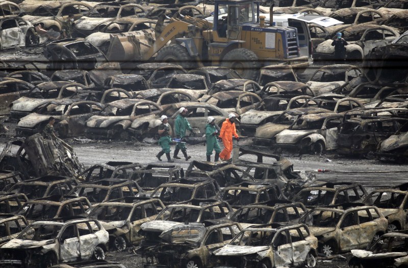 Damaged vehicles are seen at the site of explosions at the Binhai new district in Tianjin. Tianjin Blasts,New Cars Ruined,Ten thousands New Cars Ruined,Damaged cars,Cars Ruined in Tianjin Blasts