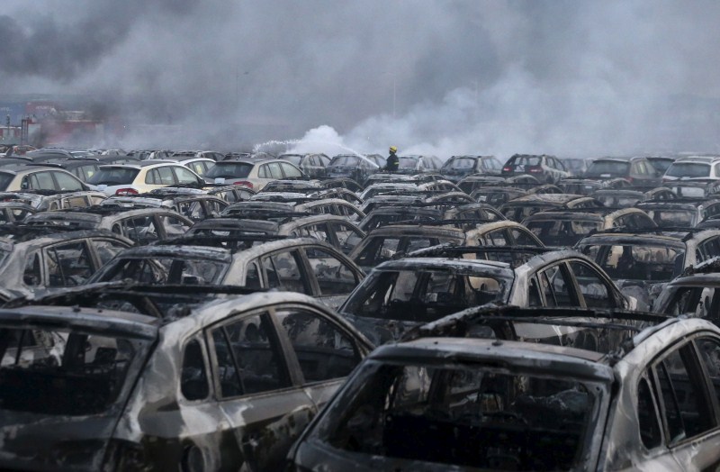 Damaged vehicles are seen at the site of explosions at the Binhai new district in Tianjin. Tianjin Blasts,New Cars Ruined,Ten thousands New Cars Ruined,Damaged cars,Cars Ruined in Tianjin Blasts