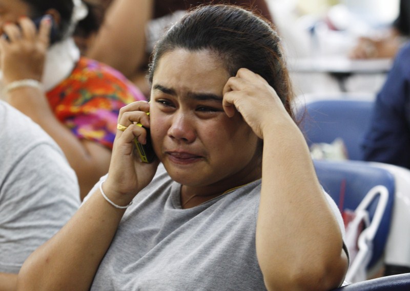 Relatives cry as they remove the body of Suwan Sudmun, a Thai victim of Monday's bomb blast, at the Institute of Forensic Medicine in Bangkok, Thailand, August 18, 2015. Thai authorities said on Tuesday they were looking for a suspect seen on closed-circuit television (CCTV) footage near the renowned shrine where a bomb blast killed 22 people, including nine foreigners from several Asian countries. Bangkok Blast,Mourning Kin of Victims,Mourning Bangkok Bomb Victims,Bangkok Bomb Victims,Mourning