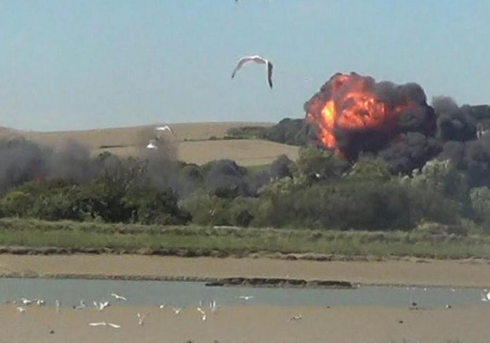 A military jet taking part in the Shoreham Air Show crashed into a busy main road on Saturday, killing 11 people and injuring more than a dozen others.The Hawker Hunter fighter jet crashed near Brighton after the pilot failed to pull out of a loop manoeuvre. Videos and photos of the deadly accident shared on social media shows, the Hawker Hunter fighter jet going in up in the sky, before plummeting speedily into the busy road. A huge fireball is seen erupting through the tress amid plumes of black smoke folowing the crash. Shoreham Air Show plane crash,military jet crashes at air show,airshow,Hawker Hunter fighter jet,images of shoreham airshow crash,British airshow,crash,plane crash,airshow plane crashes