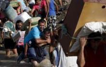 People cross the Tachira river border as Venezuela steps up deportation of Colombians in what it says is an effort to crack down on paramilitary gangs.