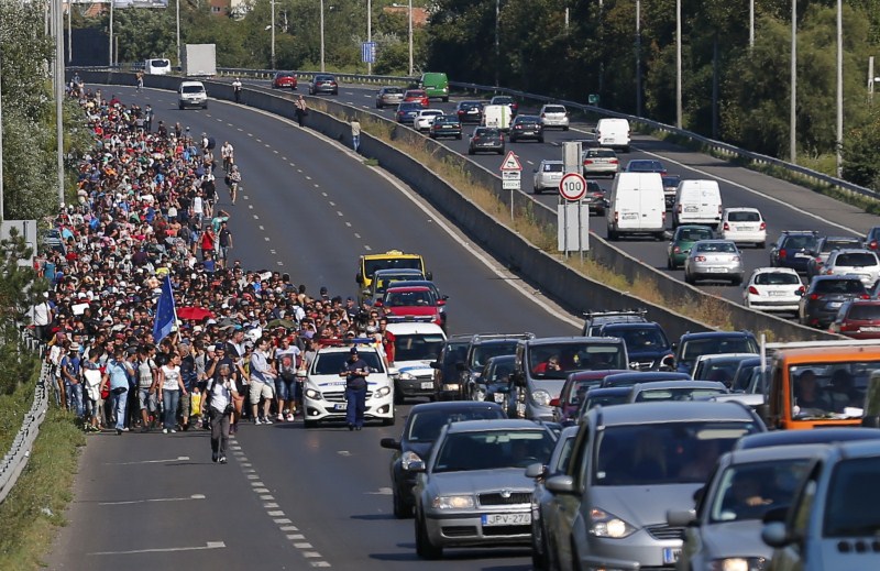 Migrants march along the highway towards the border with Austria, out of Budapest, Hungary. Hundreds of migrants,Budapest,Austria,The long march to Austria,Migrants,refugees