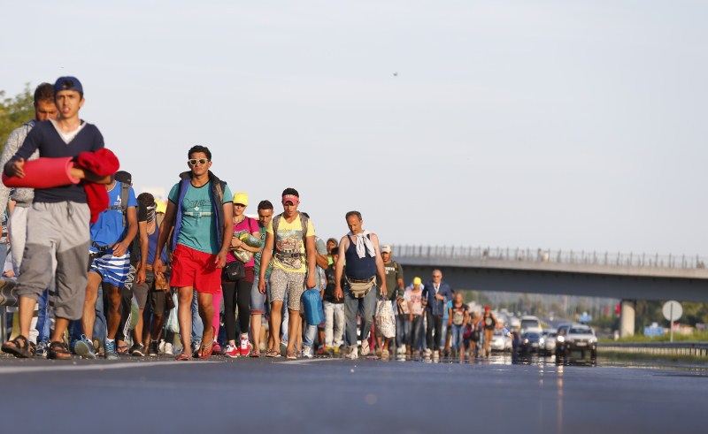 Migrants march along the highway towards the border with Austria, out of Budapest, Hungary. Hundreds of migrants,Budapest,Austria,The long march to Austria,Migrants,refugees