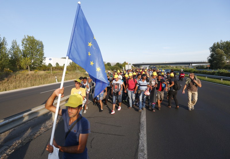 Migrants march along the highway towards the border with Austria, out of Budapest, Hungary. Hundreds of migrants,Budapest,Austria,The long march to Austria,Migrants,refugees
