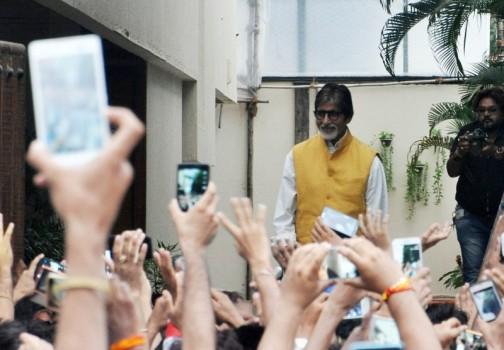 Bollywood Actor Amitabh Bachchan waves to his fans outside his Bungalow.