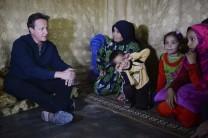 Prime Minister David Cameron visits a Syrian refugee settlement camp in the Bekaa Valley in Lebanon, September 14, 2015.