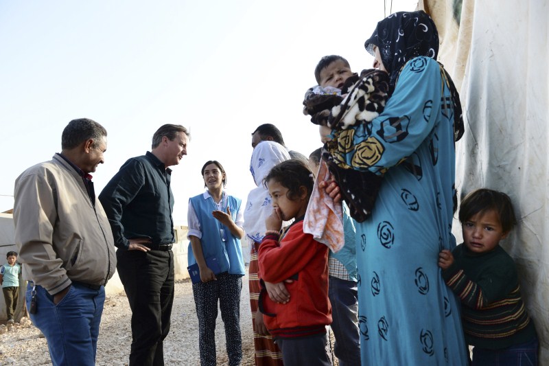 Prime Minister David Cameron visits a Syrian refugee settlement camp in the Bekaa Valley in Lebanon, September 14, 2015. David Cameron,David Cameron meets refugees in Lebanon camp,Prime Minister David Cameron,Bekaa Valley in Lebanon,Bekaa Valley,Lebanon,refugees,Syrian refugee