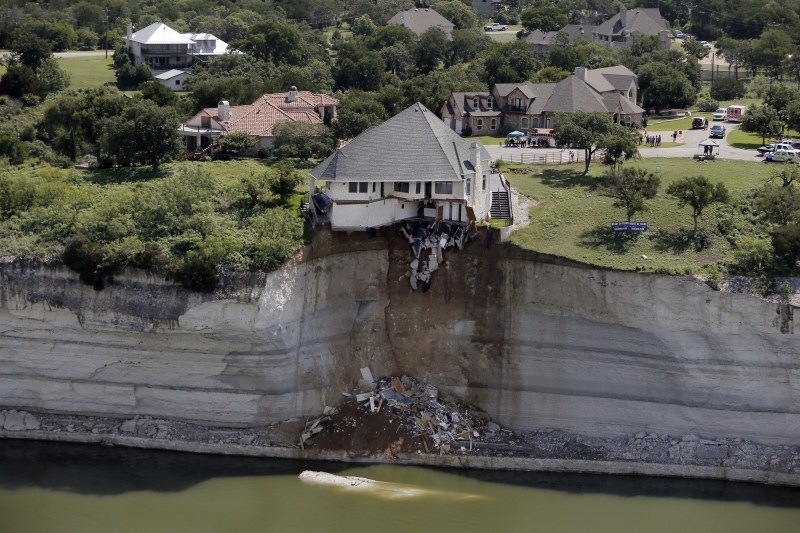 Houses teetering on the brink after being buffeted by natural disasters from typhoons to landslides. Houses on the Edge,landslides