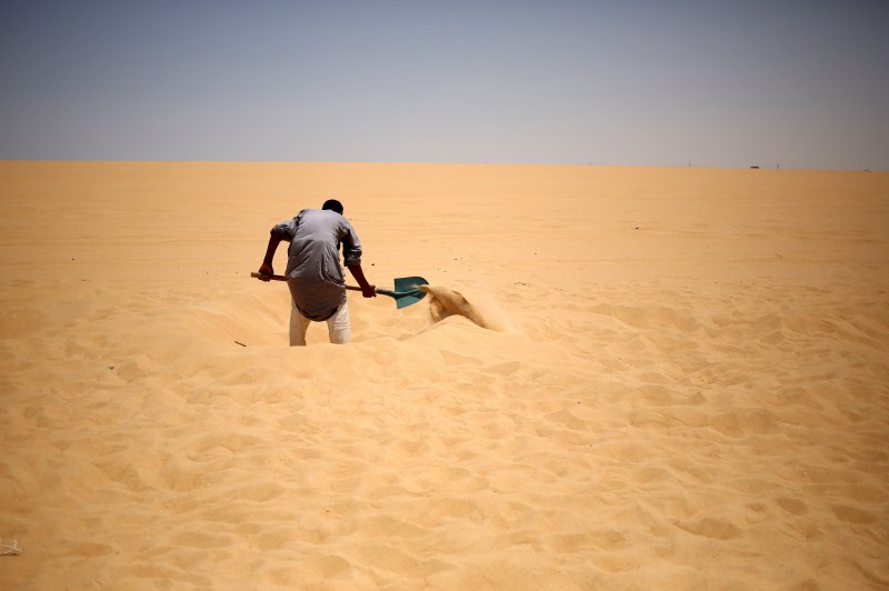 Patients relax in the shade before treatment, which includes massages by the feet of health workers who also submerge their patients up to their neck in the desert. Patients drink mint tea in tents following the treatment. Hot Sand Baths of Siwa,Hot Sand Baths,Patients Sand Baths of Siwa,desert,Patients,treatment,sand bath treatment,sand bath
