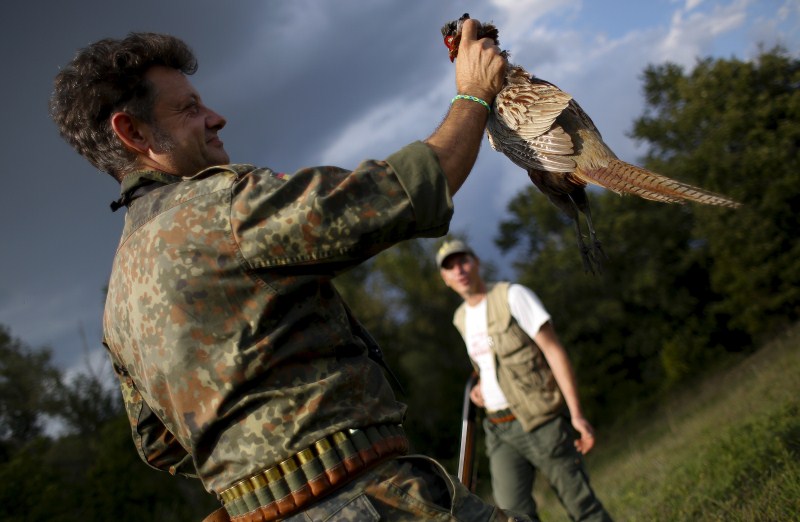 As the sun rises, hunters trek into the fields for the first day of the season in Castell'Azzara, Italy. First day of the Italy hunting season,Italy hunting season,Hunting season in Italy,Hunting in Italy