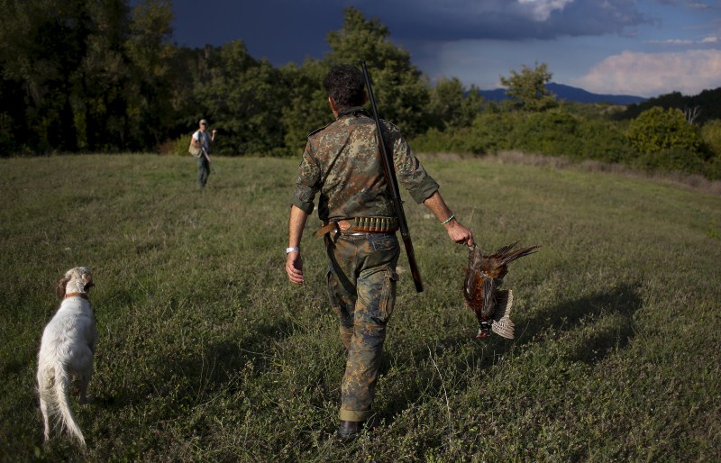 As the sun rises, hunters trek into the fields for the first day of the season in Castell'Azzara, Italy. First day of the Italy hunting season,Italy hunting season,Hunting season in Italy,Hunting in Italy