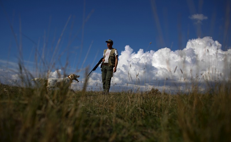 As the sun rises, hunters trek into the fields for the first day of the season in Castell'Azzara, Italy. First day of the Italy hunting season,Italy hunting season,Hunting season in Italy,Hunting in Italy