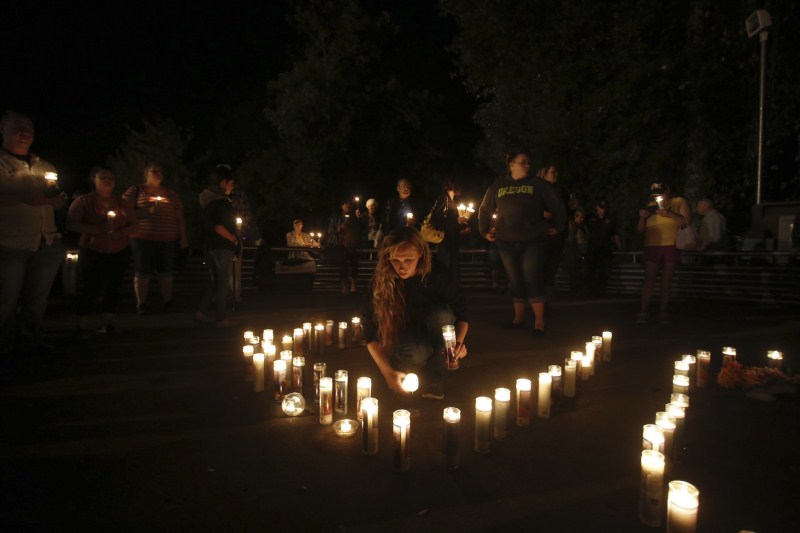 The aftermath of the shooting at Umpqua Community College in Roseburg, Oregon. Oregon school shooting,Oregon shooting,school shooting,Candlelight prayer at Roseburg's Stewart Park,Candlelight prayer,Roseburg's Stewart Park,Umpqua Community College,Umpqua College