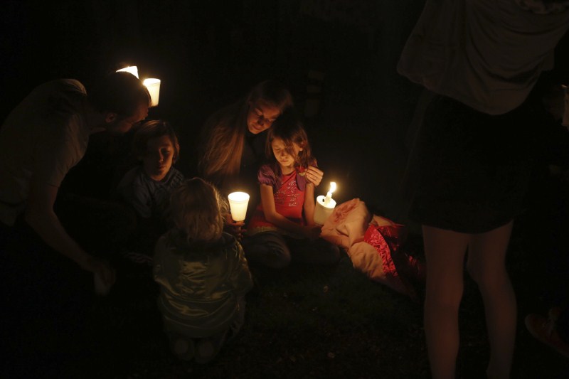 The aftermath of the shooting at Umpqua Community College in Roseburg, Oregon. Oregon school shooting,Oregon shooting,school shooting,Candlelight prayer at Roseburg's Stewart Park,Candlelight prayer,Roseburg's Stewart Park,Umpqua Community College,Umpqua College