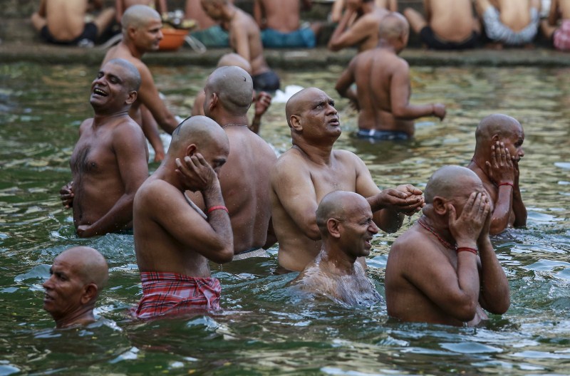 Hindu devotees pray in a holy pond on the auspicious day of Mahalaya in Mumbai, India, on 12 October 2015. Hindus offer prayers with holy water after taking a dip in the river to honor the souls of their departed ancestors during Mahalaya, which is also called Shraadh or Pitru Paksha. Mahalaya Amavasya,Shraadh,Pitru Paksha,Mahalaya Amavasya celebration,Mahalaya Amavasya 2015,Shubho Mahalaya