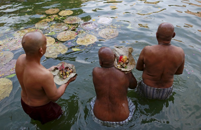 Hindu devotees pray in a holy pond on the auspicious day of Mahalaya in Mumbai, India, on 12 October 2015. Hindus offer prayers with holy water after taking a dip in the river to honor the souls of their departed ancestors during Mahalaya, which is also called Shraadh or Pitru Paksha. Mahalaya Amavasya,Shraadh,Pitru Paksha,Mahalaya Amavasya celebration,Mahalaya Amavasya 2015,Shubho Mahalaya