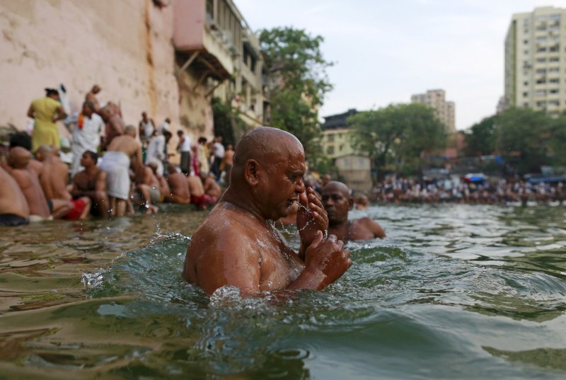 Hindu devotees pray in a holy pond on the auspicious day of Mahalaya in Mumbai, India, on 12 October 2015. Hindus offer prayers with holy water after taking a dip in the river to honor the souls of their departed ancestors during Mahalaya, which is also called Shraadh or Pitru Paksha. Mahalaya Amavasya,Shraadh,Pitru Paksha,Mahalaya Amavasya celebration,Mahalaya Amavasya 2015,Shubho Mahalaya