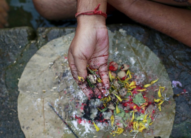 Hindu devotees pray in a holy pond on the auspicious day of Mahalaya in Mumbai, India, on 12 October 2015. Hindus offer prayers with holy water after taking a dip in the river to honor the souls of their departed ancestors during Mahalaya, which is also called Shraadh or Pitru Paksha. Mahalaya Amavasya,Shraadh,Pitru Paksha,Mahalaya Amavasya celebration,Mahalaya Amavasya 2015,Shubho Mahalaya