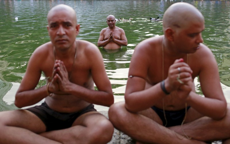 Hindu devotees pray in a holy pond on the auspicious day of Mahalaya in Mumbai, India, on 12 October 2015. Hindus offer prayers with holy water after taking a dip in the river to honor the souls of their departed ancestors during Mahalaya, which is also called Shraadh or Pitru Paksha. Mahalaya Amavasya,Shraadh,Pitru Paksha,Mahalaya Amavasya celebration,Mahalaya Amavasya 2015,Shubho Mahalaya