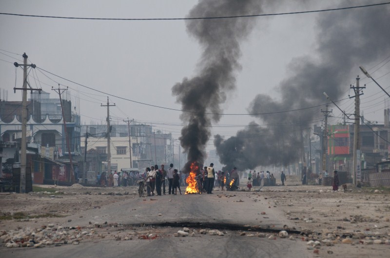 Nepalese Madhesi protestors burn tyres to block a highway connecting Nepal and India during a strike against the new constitution in Birgunj, Nepal on 5 November 2015. Birgunj Protest in Nepal,Birgunj Protest,Birgunj,Birgunj peoples,Madhesi protestors,Madhesi