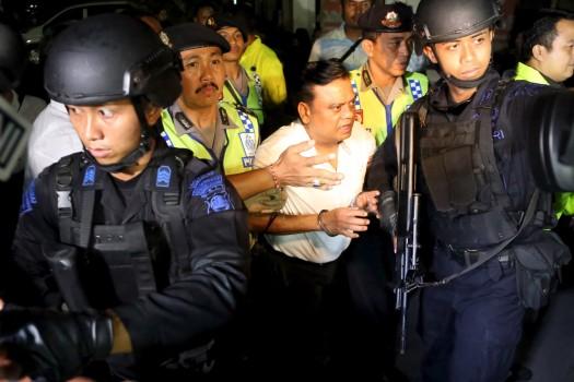 Indian security personnel stand guard at the gate of the airport before the believed arrival of India's most-wanted man, Rajendra Nikalje, widely known as Chhota Rajan, in New Delhi