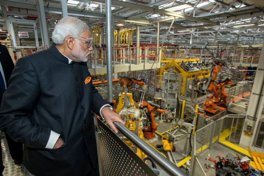 The PM was shown around the facility at Solihull in England by Tata Group chairman Cyrus Mistry, Jaguar Land Rover (JLR) CEO Ralf Speth Narendra modi,narendra modi visits JLR plant,JLR plant,Jaguar land rover plant,modi at Jaguar Land Rover plant,modi UK visit,Modi trips