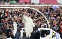 Pope Francis waves to faithful as he arrives for a Papal mass in Kenya's capital Nairobi.