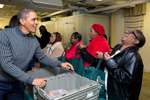 U.S. President Barack Obama, his daughter Malia and First Lady Michelle Obama serve thanksgiving dinner at Friendship Place Homeless Center at the St. Luke's Methodist church in Washington. Thanksgiving 2015,Thanksgiving day,Barack Obama,Malia Obama,Michelle Obama,thanksgiving dinner,Friendship Place Homeless Center
