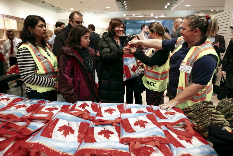 The first plane load of Syrian refugees arrived in Toronto on a military aircraft. Canada Welcomes Syrian Refugees,Syrian Refugees,Canada prime minister,Canada prime minister welcomes wave of Syrian refugees,Justin Trudeau