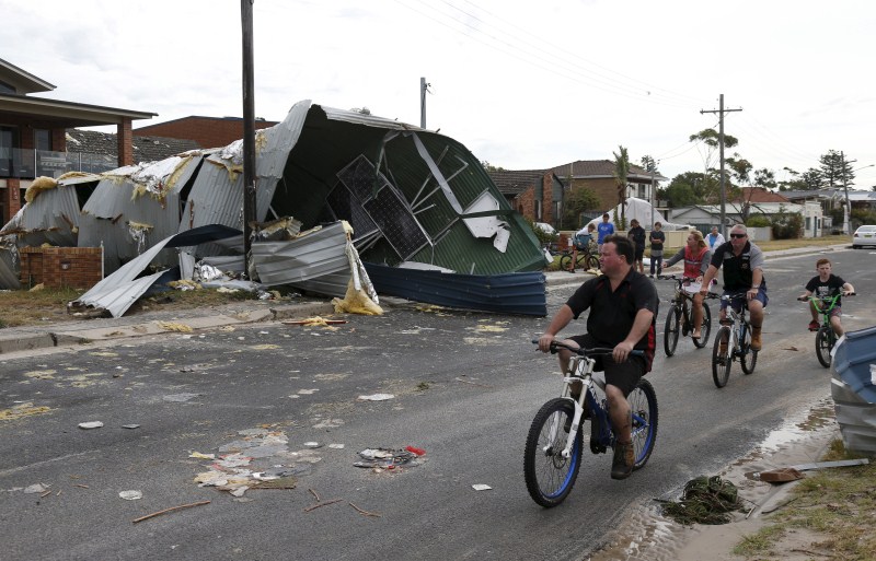 A rare tornado hits the suburbs of Sydney with destructive winds above 200km an hour (125 mph) and cricket ball-sized hail, bringing down trees and power lines, sheering off roofs and causing flash flooding in Australia’s largest city. Rare tornado,Tornado takes Sydney,Tornado hits Sydney,thunderstorms,thunderstorms hits Australia,thunderstorms hits Sydney