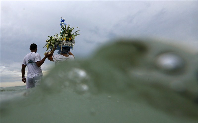 Worshippers present gifts to the sea goddess at the end of every year, to give thanks and ask for blessings for the upcoming new year. New Year 2016,New Year,Afro-Brazilian religion Umbanda,Afro-Brazilian,Umbanda followers,welcome New Year,New Year welcome,happy new year
