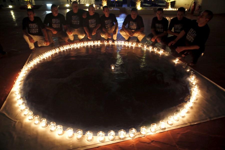 Members of 'Peace Time' place candles in the shape of the Earth Earth Hour 2015,28 March,spectacular images,climate change,black out,lights off,photos