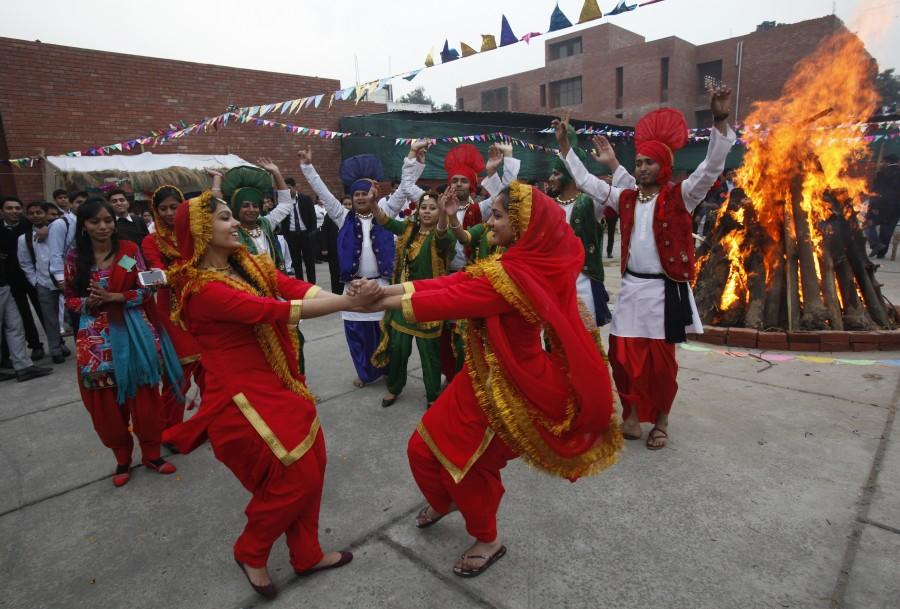 Lohri festival marks the culmination of winter in many parts of northern India. Here are some photos of Lohri festival celebration across India. Lohri,Lohri festival celebration,Lohri festival celebration in India,Lohri celebration in India,Lohri celebration,Lohri 2016,Lohri rituals,rituals lohri festival,Lohri Celebrations